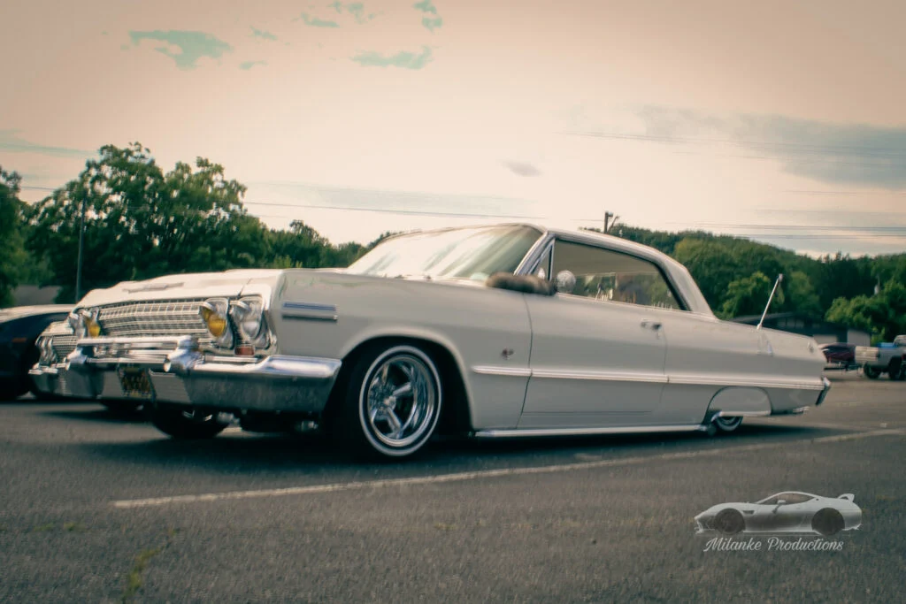 White Chevrolet Impala parked outdoors with lowered suspension and special rims
