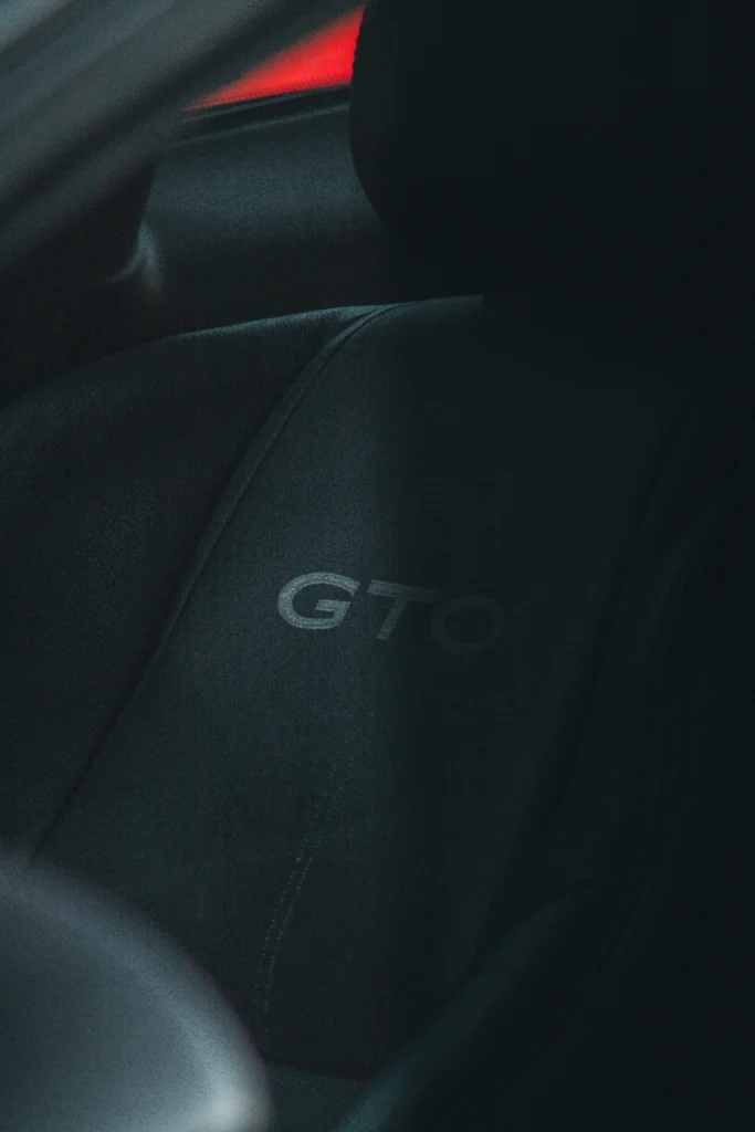 Close-up of a black car seat with GTO embroidered on it