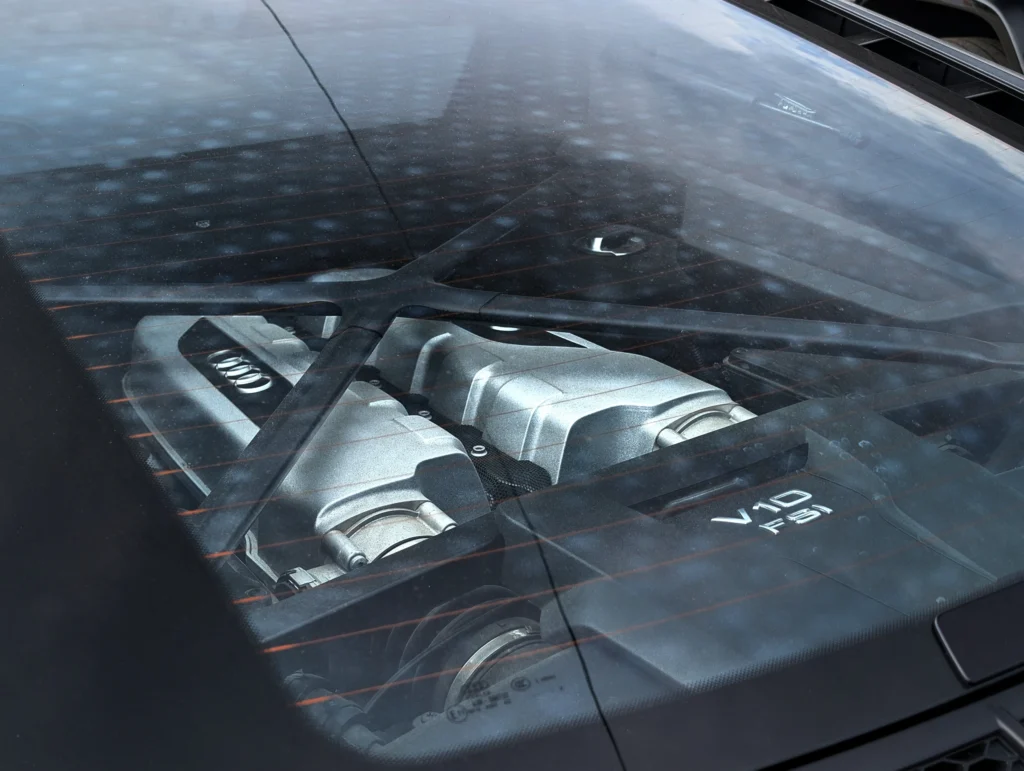 Audi V10 FSI engine visible through rear window of a car