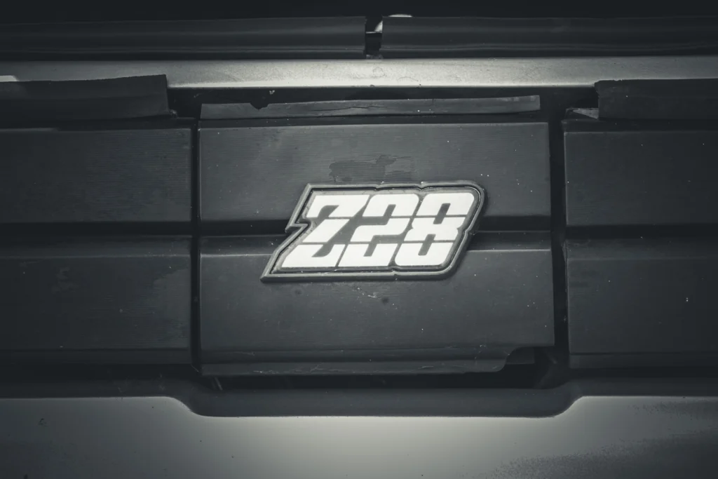 Close-up of a black engine cover with a 'Z28' emblem attached