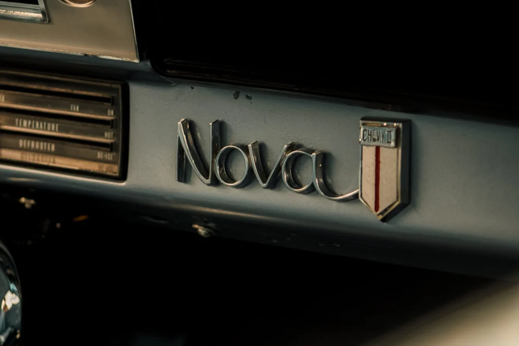 Chevy II Nova badge and dashboard temperature control panel inside a vehicle