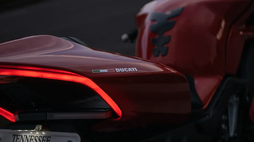 Rear section of a red Ducati motorcycle with illuminated tail light and Tennessee license plate visible
