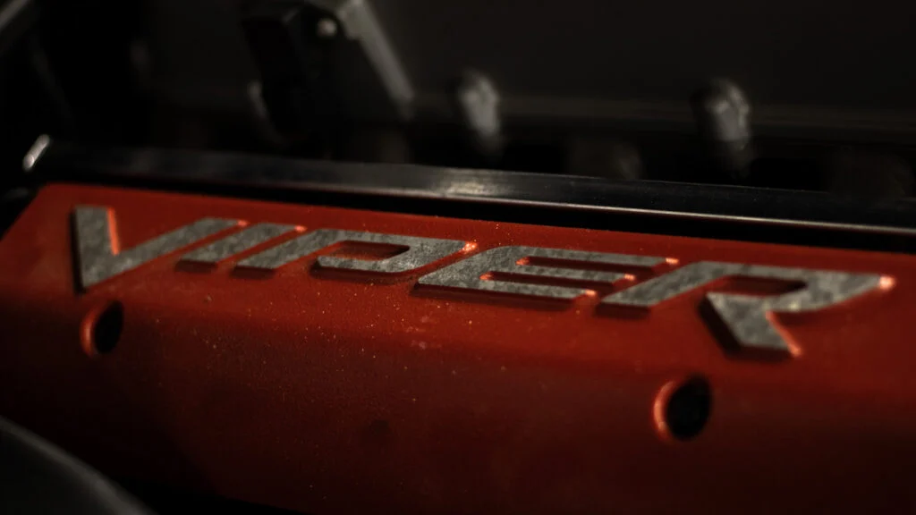 Close-up detail of an orange valve cover with the word VIPER embossed on it.