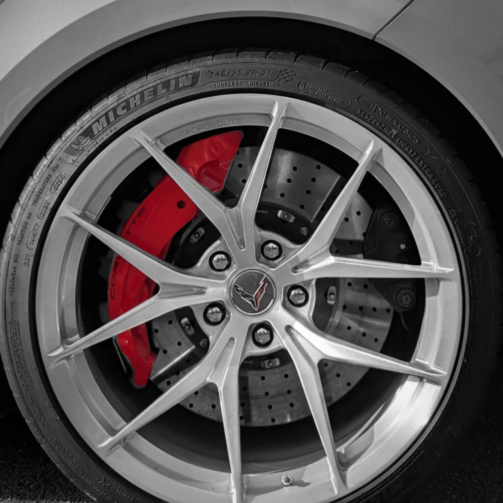 Close-up of a silver alloy wheel with a red brake caliper and Michelin tire on a Corvette ZR1