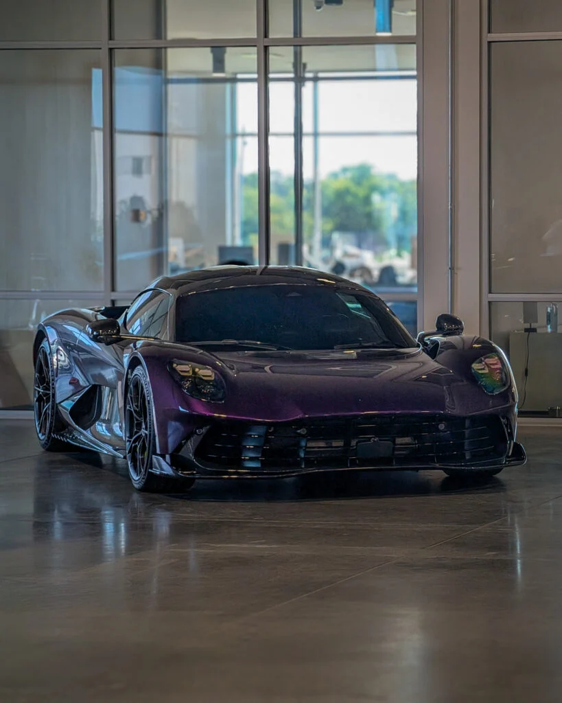 Aston Martin Valhalla displayed indoors with glass windows in the background
