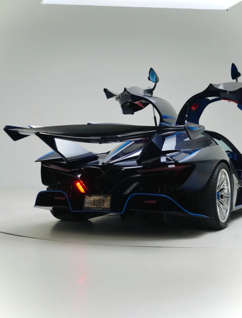 Rear view of a black Apollo IE with its butterfly doors open in a white studio.