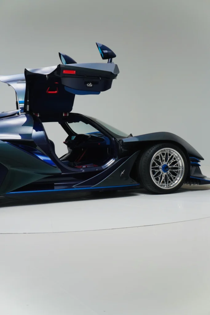 Blue Apollo IE with gullwing doors open in a studio setting