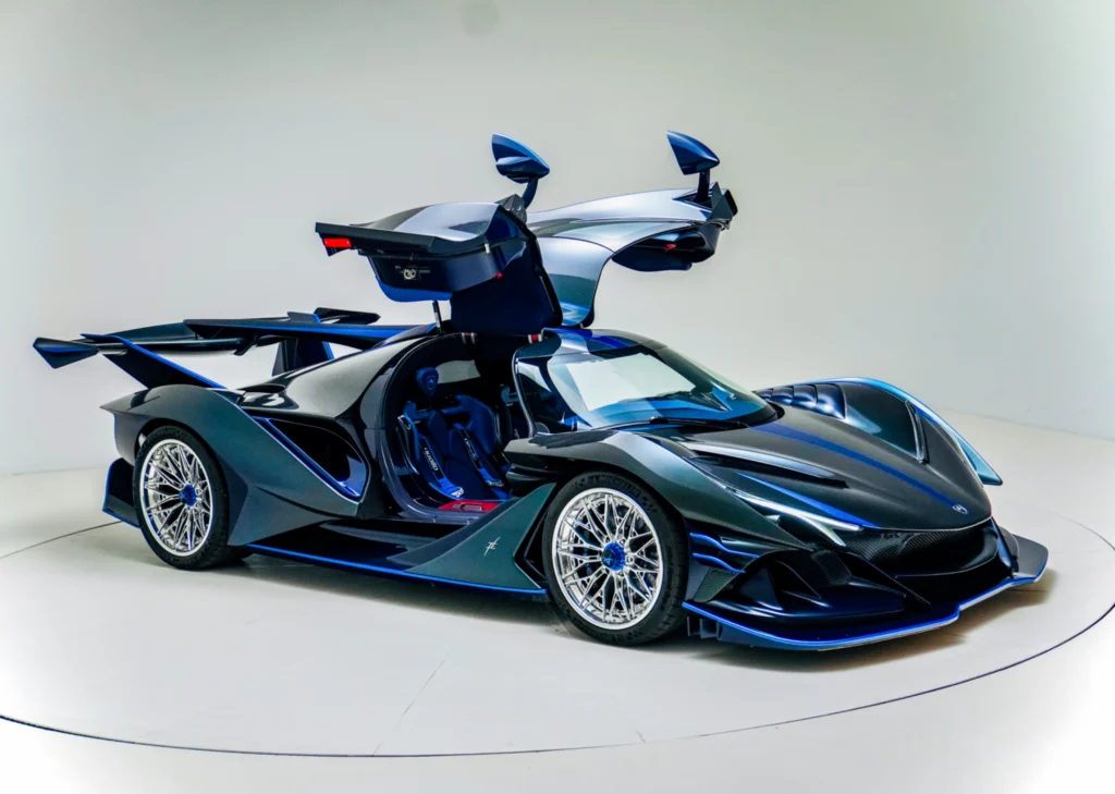 Dark blue and black Apollo IE with butterfly doors open in a studio setting