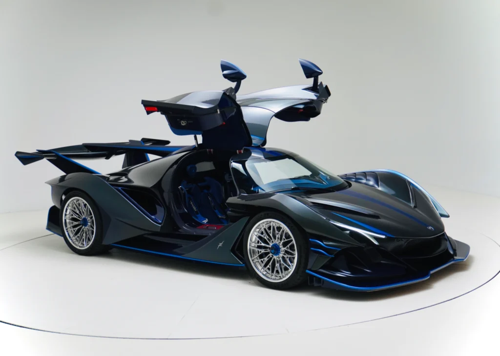 Black and blue Apollo IE with driver-side doors open in a studio.