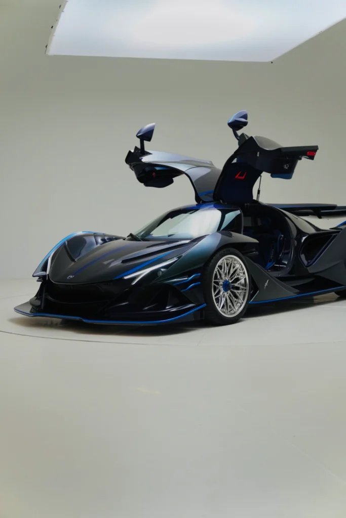 Black Apollo IE with butterfly doors open in an indoor studio setting