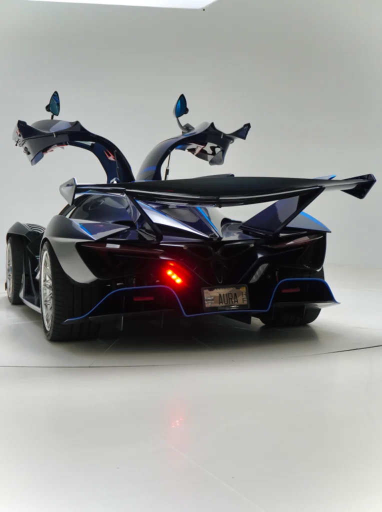 Black Apollo IE with open dihedral doors shown from rear in white studio